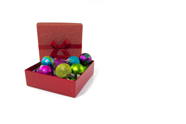 gift boxes in red with christmas balls in red silver gold blue and other colors isolated on white background