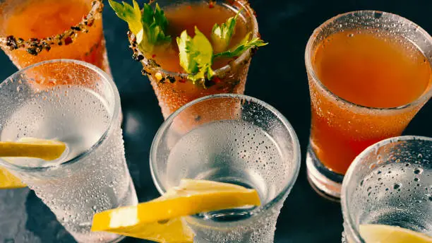 Photo of Spicy and strong alcoholic cocktails on a dark background. condensate on a glass.