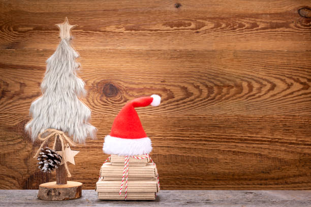 istock A Christmas tree with gifts and a red Christmas hat 1190636529