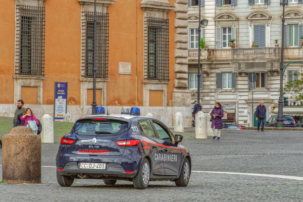 Italian military force dark blue vehicle with white roof and red stripe on side, ensuring safety on the Roman capital. stock photo