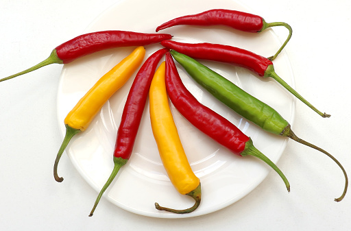 Colorful organic spicy hot peppers on plate