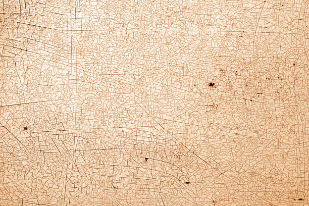 istock Cracks on metal texture in orange tone. 1190640232