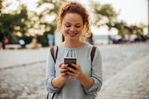 istock Orangehair girl reading a message 1190640514