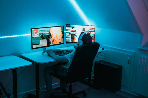 istock Playing video game online while sitting in front of gaming computer at home 1190641154