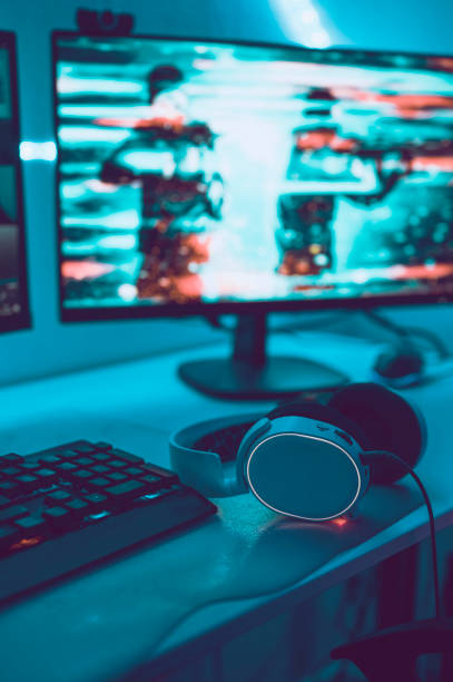 istock Focus on gaming headset next to computer running action video game 1190641497