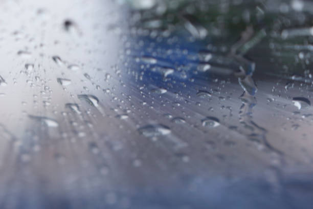 istock Selective focus. The water grains appear to form crystals dark background. Light trails from the sun. 1190641523