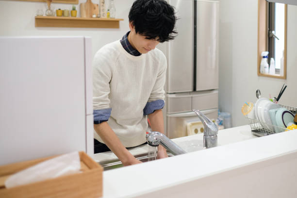 Man washing dishes in kitchen