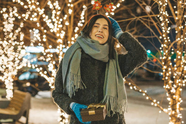 istock Young woman holding Christmas gift 1190642074