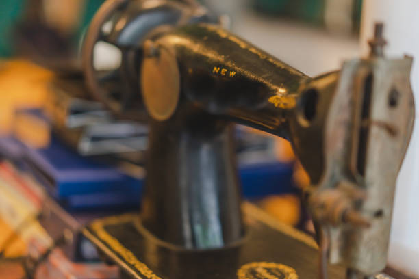 istock Measuring tape and old sewing machine on tailor table. 1190642125