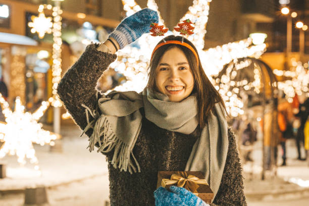 istock Young woman holding Christmas gift 1190642311
