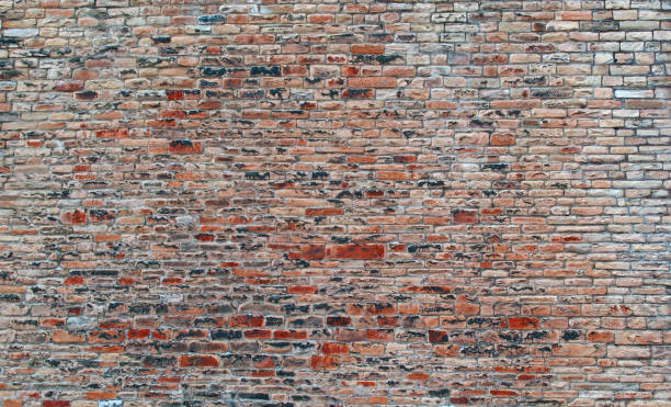 istock red outdoor stone wall with many uneven rough bricks and textured surface 1190644670