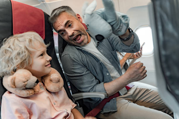 istock Happy father and son is sitting in plane 1190644741