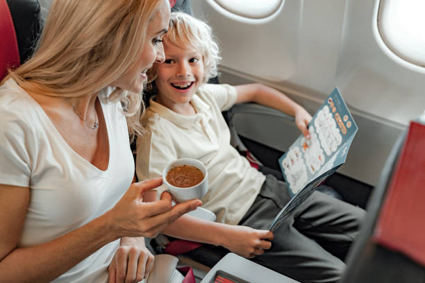 istock Smiling woman is enjoyioing coffee in plane 1190644753