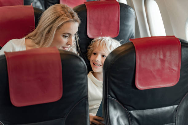istock Happy mother with her son sitting in plane 1190644800