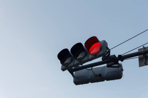istock Red traffic light ,isolated on sky background 1190644905