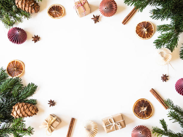 istock Flat lay creative Christmas vibrant frame with fir branches, Christmas decorations and spices on white background. Top view 1190645879