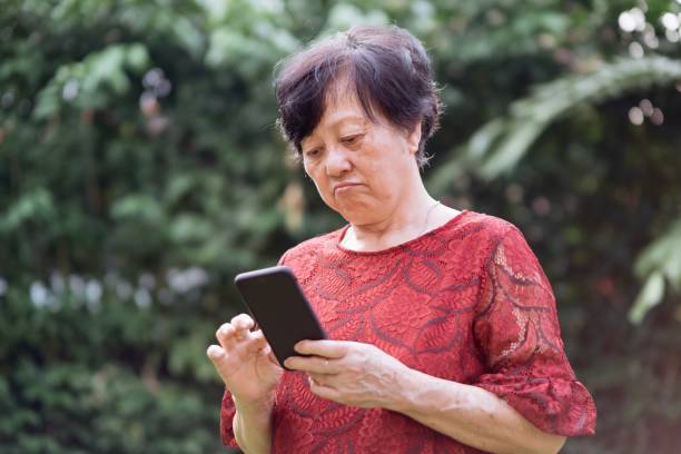 istock Beautiful Chinese Senior Women Using with Mobile Phone 1190647798