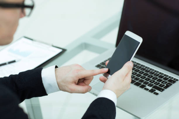 istock close up. a businessman uses a smartphone in the workplace 1190653220