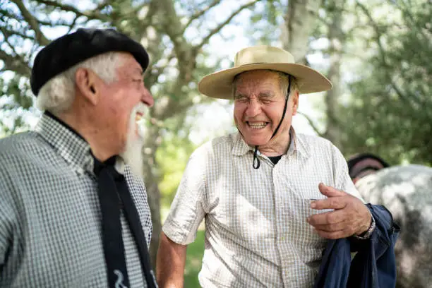 Two senior gaucho friends laughing