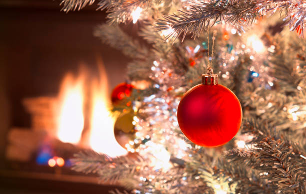 istock Growing Red Christmas Ornament handing in silver tree 1190656169