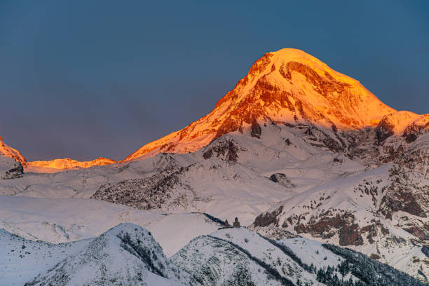 istock Panoramic view of Caucasus mountains, Gergeti Trinity church Tsminda Sameba and sunlight in a morning, landmark of Georgia 1190657376