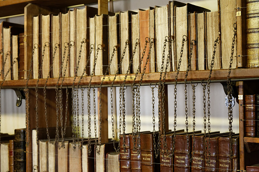 a stack of red and gold bibles