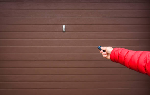 istock Hand use remote controller for closing and opening garage door 1190658948