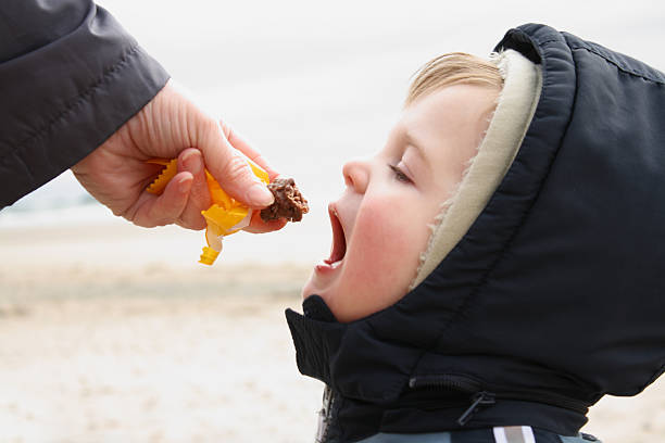 Little boy eating chocolate stock photo