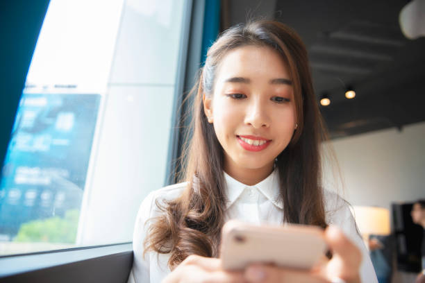 istock Female business using smartphone in company 1190659137