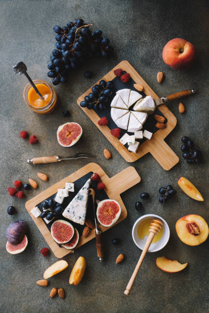istock Assortment of cheese with nuts, figs and grape on cutting board 1190659438