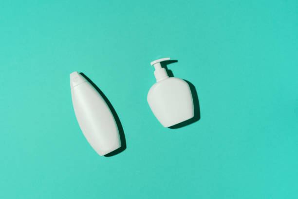 istock Shampoo and soap bottles on blue background. Top view. Flat lay. Copy space. 1190659446