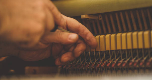 istock Instrument technician repairing a piano 1190662502