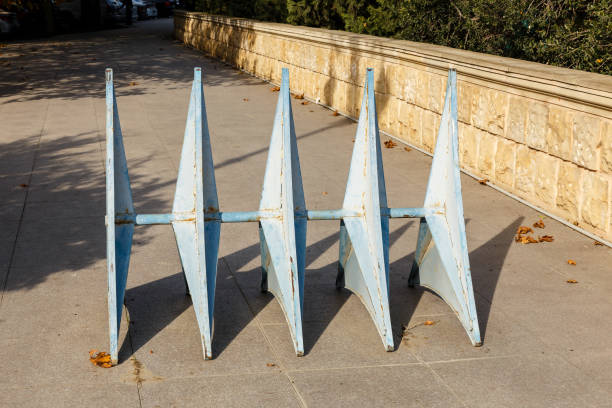 iron barrier on the sidewalk. barrier is made of steel to prevent the car from passing