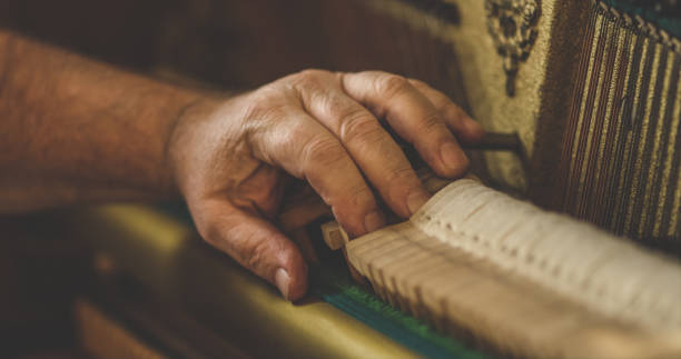 Instrument technician repairing a piano