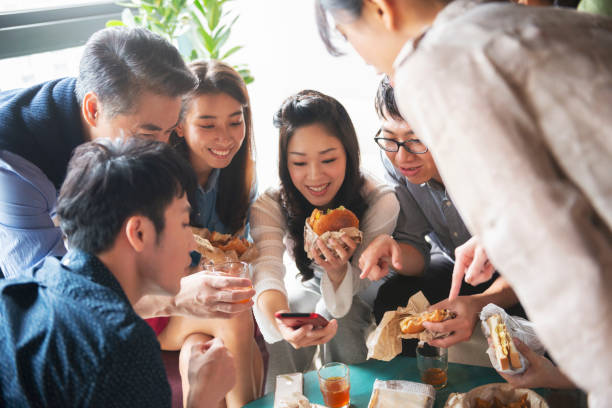 istock Team having lunch together and using smartphone 1190663020