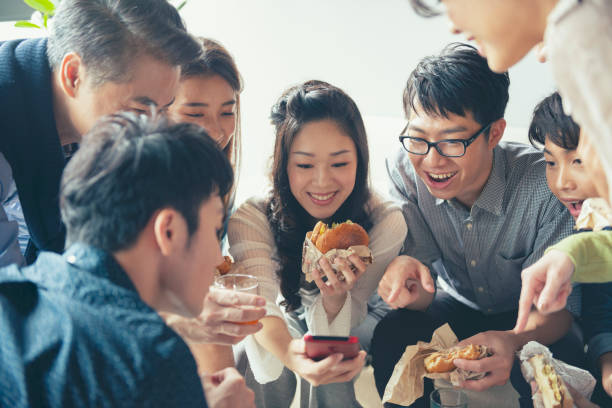 istock Team having lunch together and using smartphone 1190663034