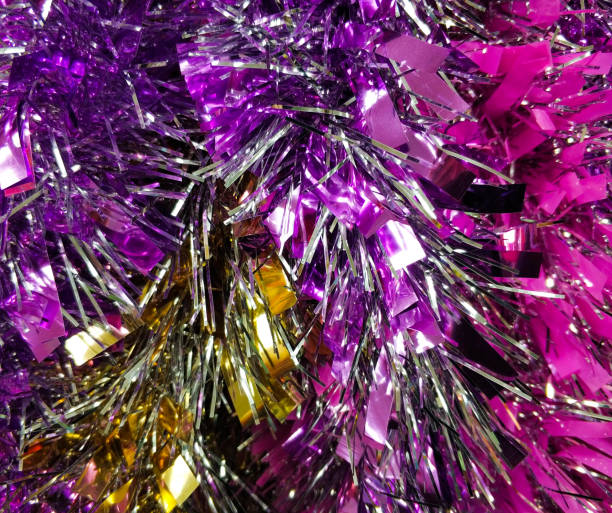 Bright christmas background from colored tinsel. Colored metal foil. Close-up. stock photo