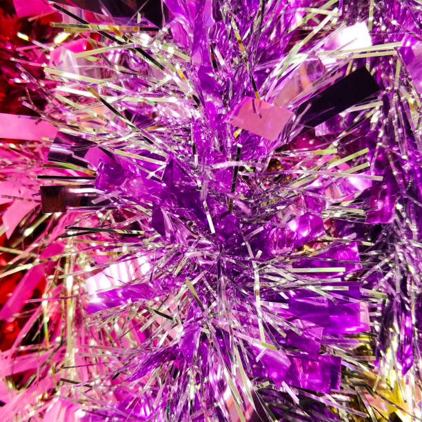 Bright christmas background from colored tinsel. Colored metal foil. Close-up. stock photo
