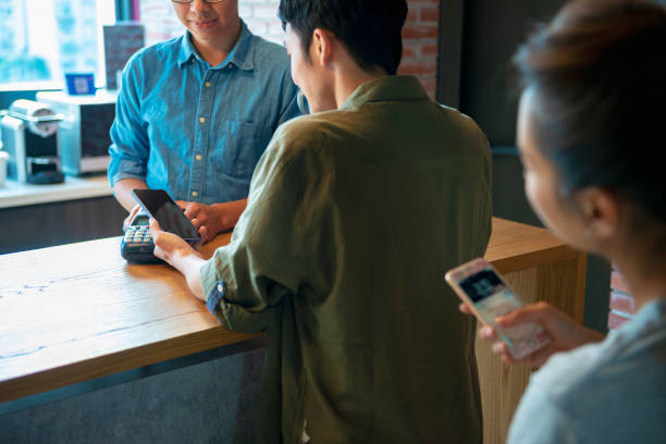 istock placing smartphone on credit card payment machine 1190664494