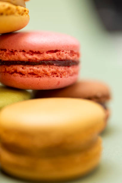 istock Colored tasty  macaroons over a green background 1190664663