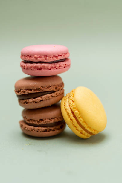 istock Colored tasty  macaroons over a green background 1190664691