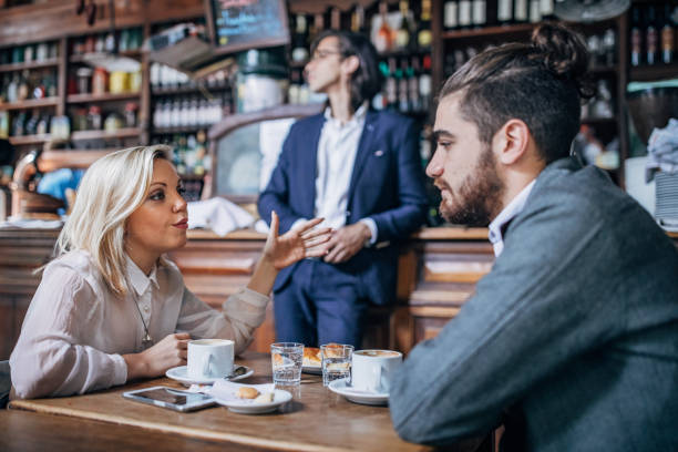 istock Couple sitting in coffee shop 1190669402