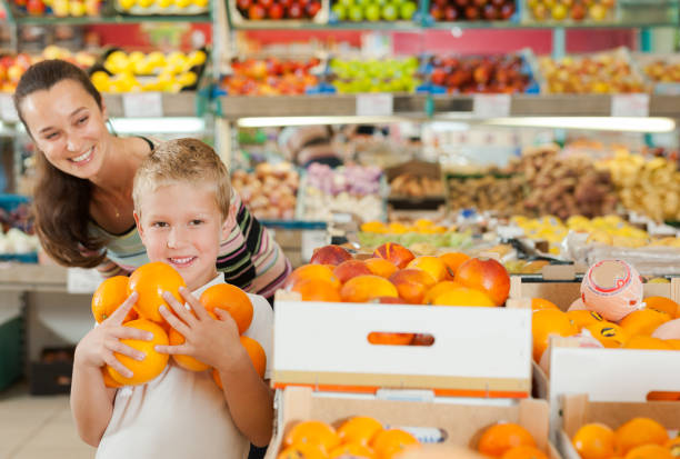istock son with female choosing fresh oranges 1190669788
