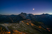 light trails on mountain pass road high up in european alps