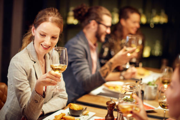 istock Woman drinking wine in restaurant. 1190672858