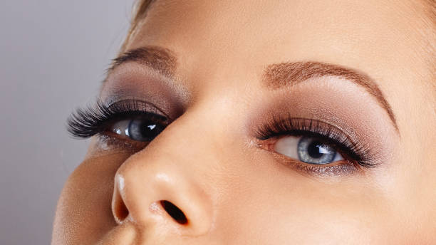 istock Woman face with long eyelashes and smokey eyes make-up 1190675946