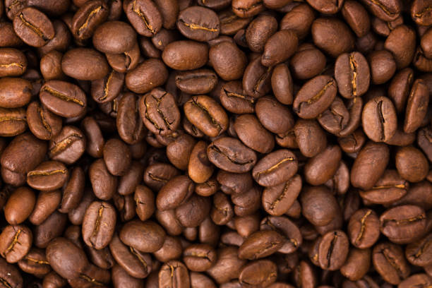 istock fresh Roasted coffee beans closeup. Background textured 1190677814