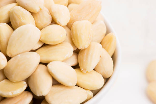 istock Bowl of almonds on a white background 1190679201