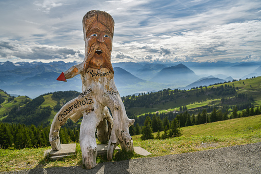 Rigi Kulm, Switzerland - September 22, 2019: Wooden sculpture made from old tree standing close to train station on top of Mount Rigi in Switzerland during sunny autumn day in 2019