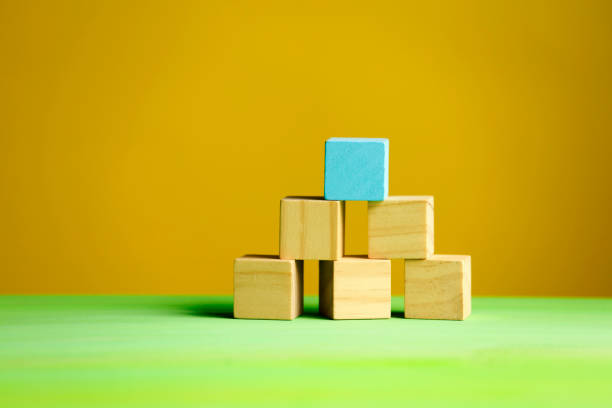 istock Wooden blocks on green background 1190679487